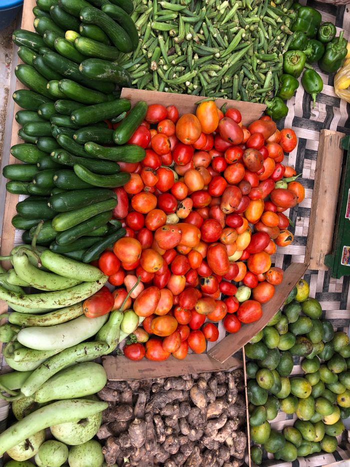A vibrant assortment of fresh vegetables displayed at an outdoor market stall, showcasing healthy living.
